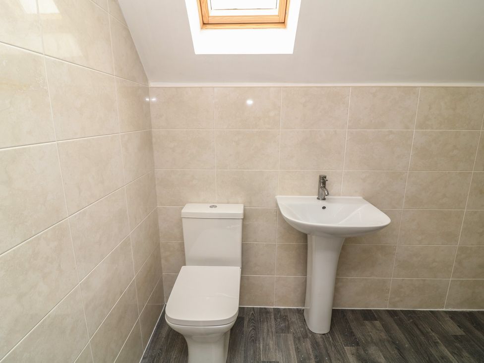 A bathroom with a toilet and sink at Ruby Red in Brigg