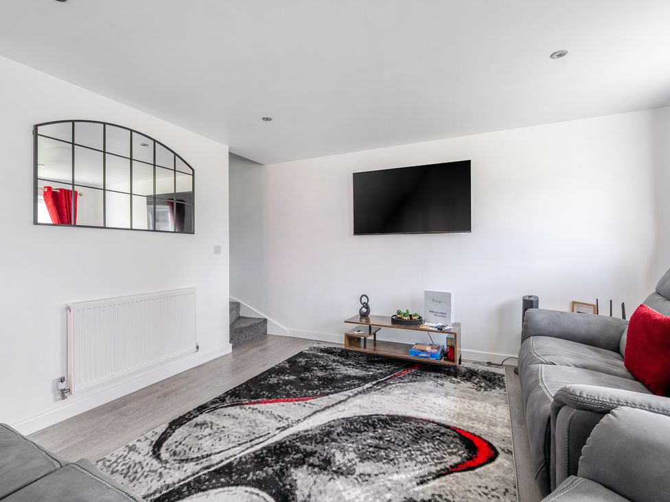 A living room with a sofa and television at Ruby Red Near Brigg