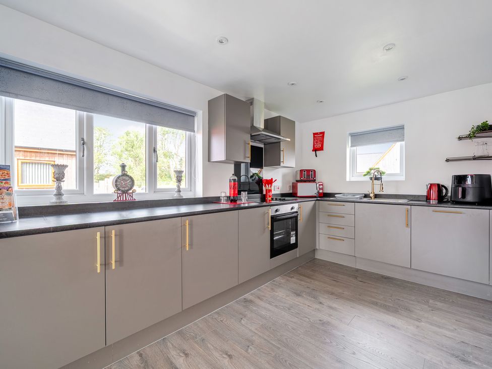 A kitchen with appliances and cabinets at Ruby Red near Brigg