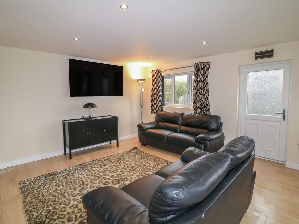 A living room with a television and sofa at Poker Lodge in Brigg