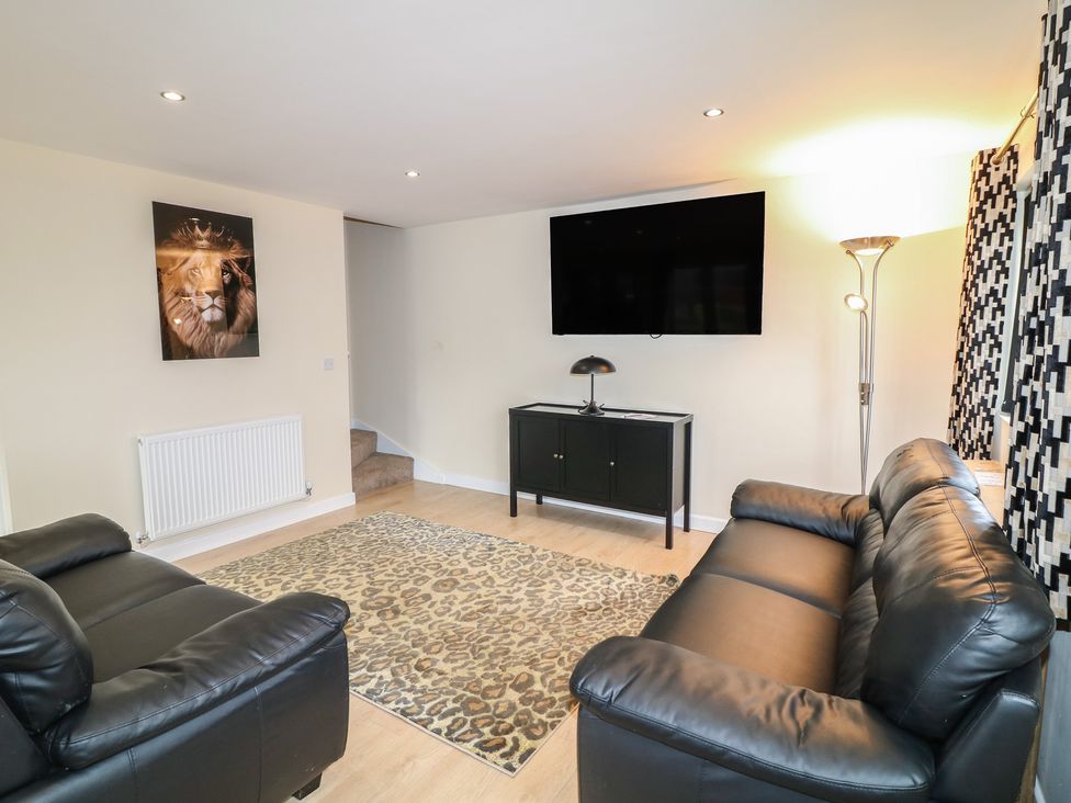 A living room with a sofa and television at Poker Lodge in Brigg