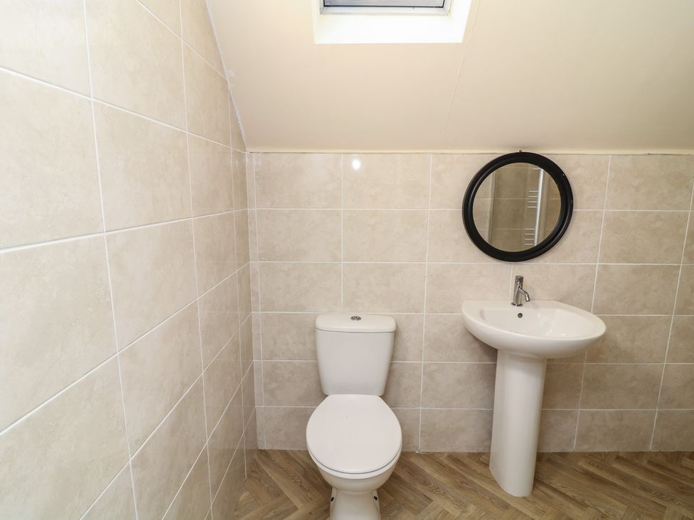A bathroom with a toilet and sink at Poker Lodge in Brigg