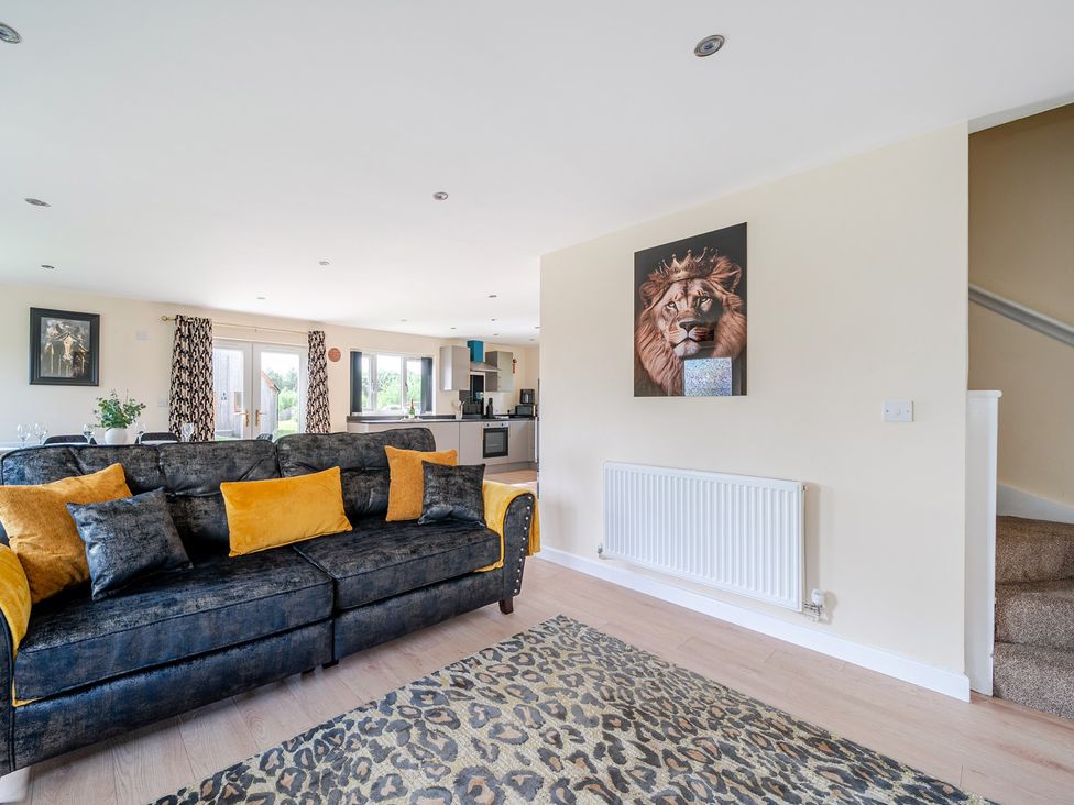 A living room with a sofa and rug at Poker Lodge near Brigg