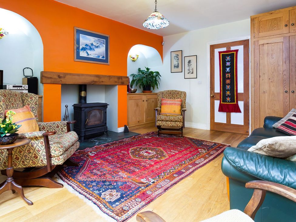 A living room with an armchair and a sofa at Oakdene in Keswick