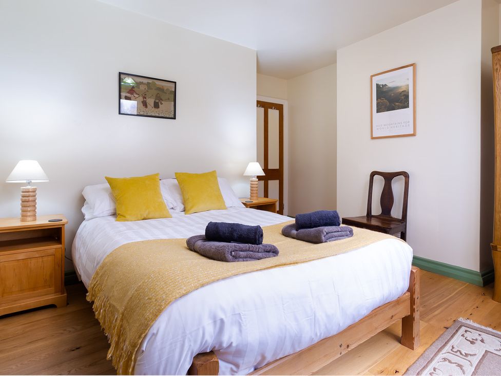 A bedroom with a bed and lamps at Oakdene in Keswick