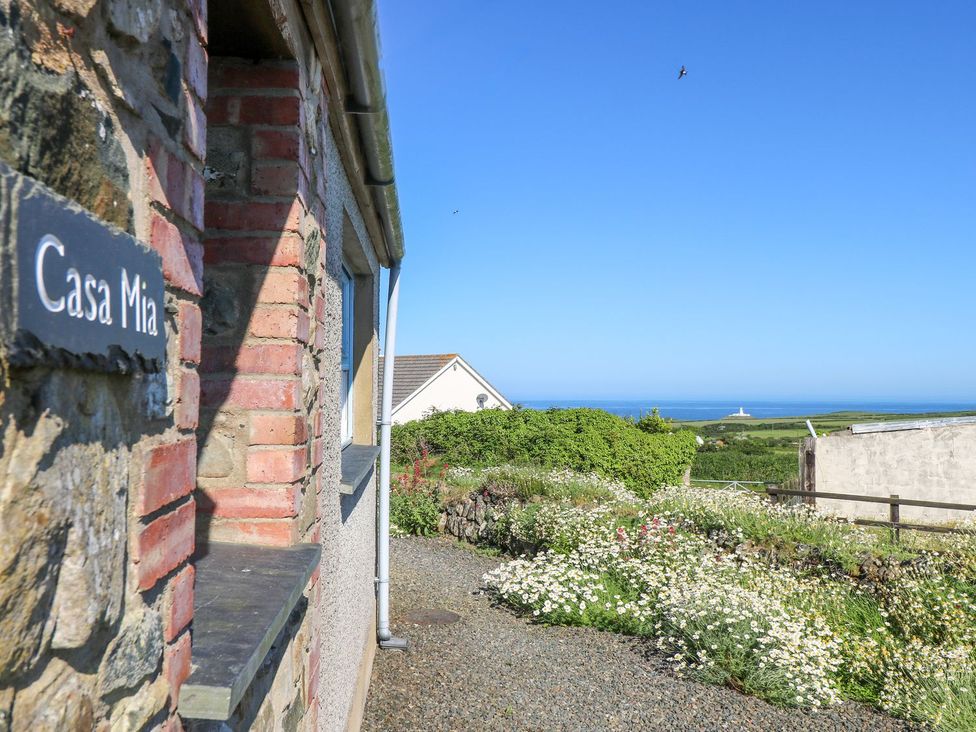 A view of Casa Mia with a garden and ocean in the background at Casa Mia Goodwick