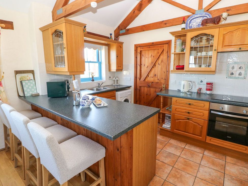 A kitchen with wooden cabinets and a countertop at Casa Mia in Goodwick