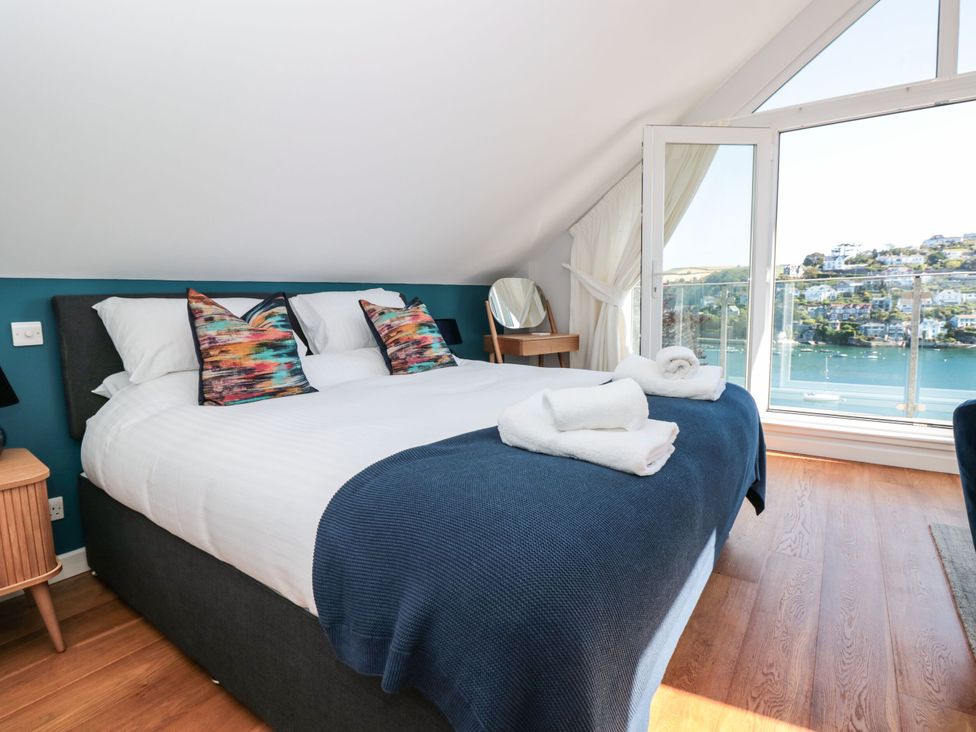 A bedroom with a bed and balcony view at Galvayne in Dartmouth
