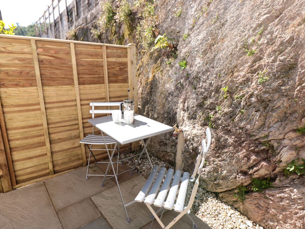 An outdoor seating area with a table and chairs at Galvayne Dartmouth
