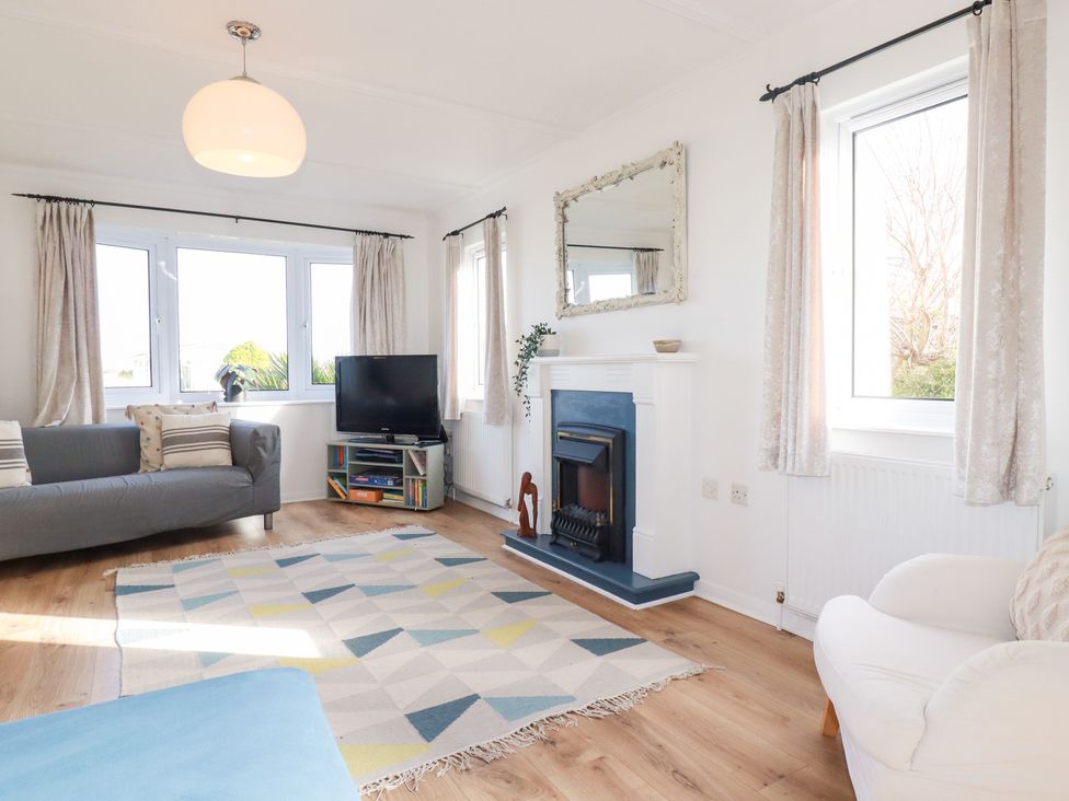 A living room with a sofa and a television at Ms Merryn 37 St. Cadocs