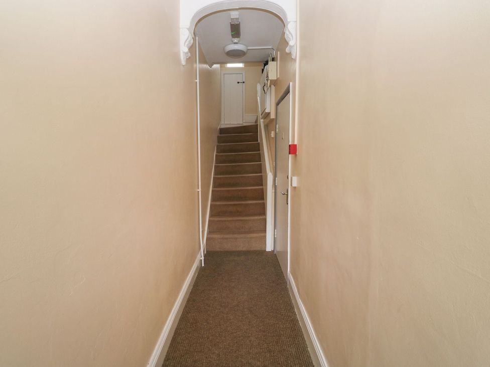 A staircase and door in a hallway at The English School, Flat 2 Dartmouth