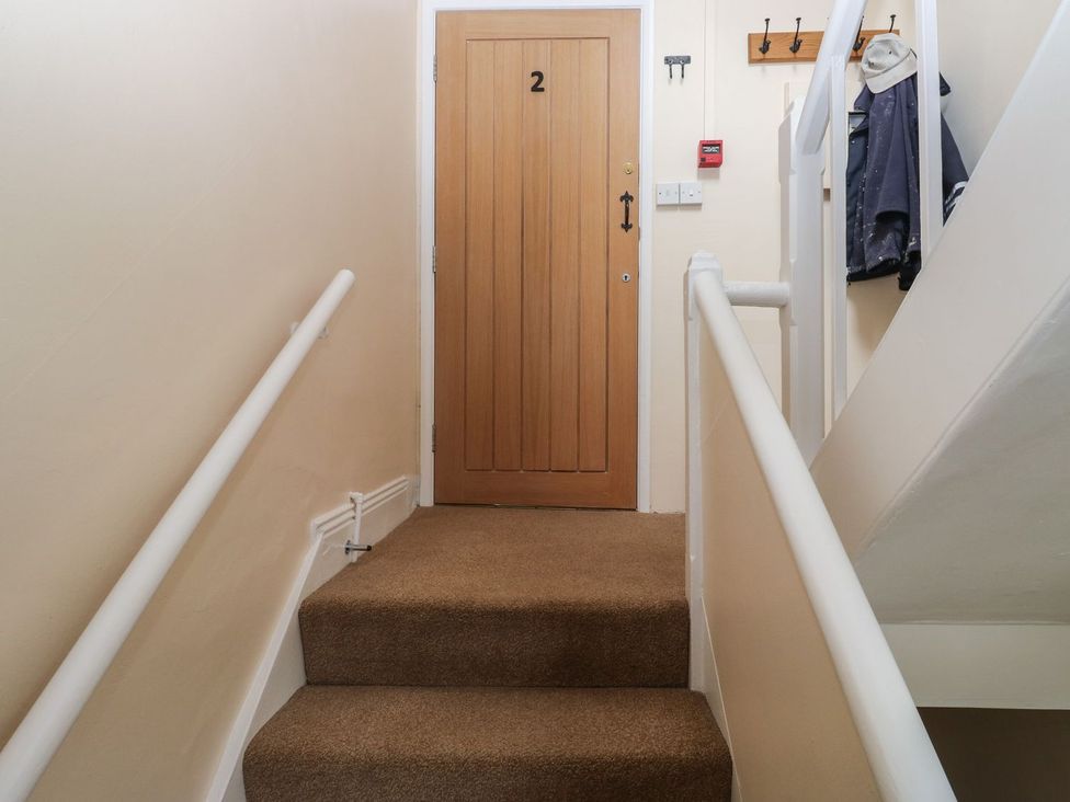 A staircase leading to a door with number 2 at The English School, Flat 2 in Dartmouth