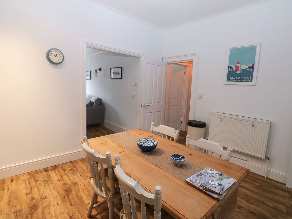 A dining room with a table and chairs at The English School, Flat 2 Dartmouth