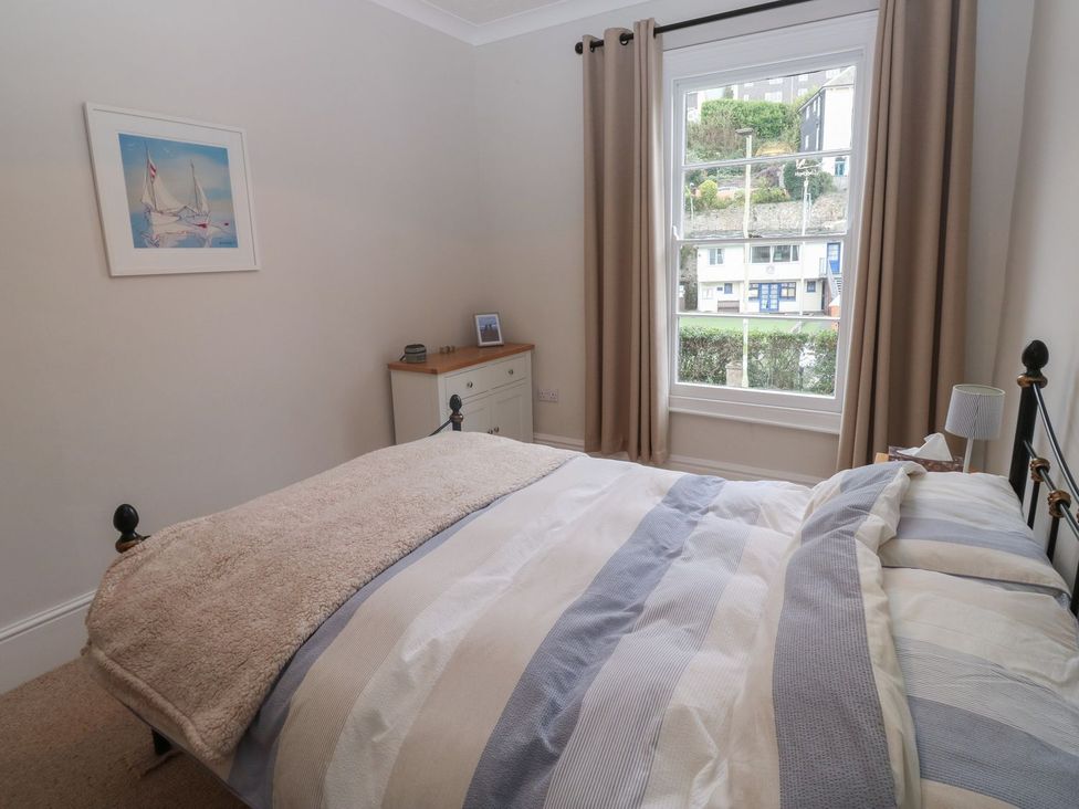 A bedroom with a bed and a window at The English School, Flat 2 in Dartmouth