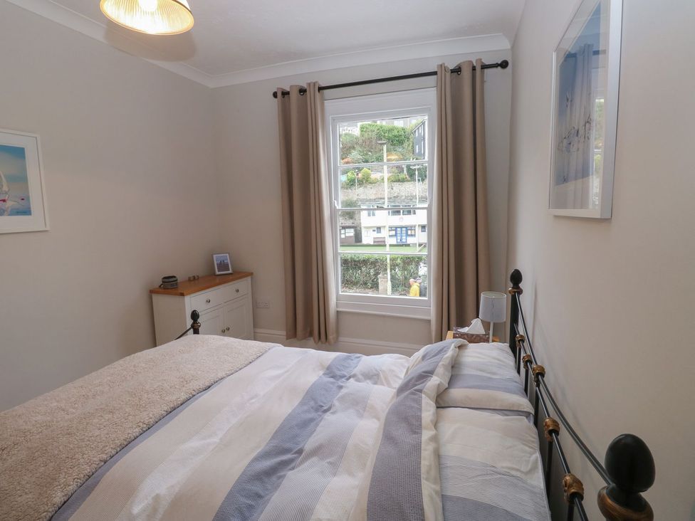 A bedroom with a bed and window at The English School, Flat 2 in Dartmouth