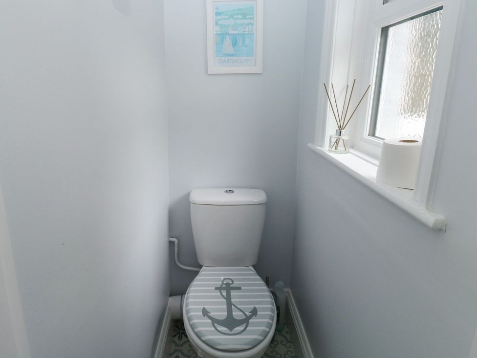 A bathroom with a toilet and a framed picture at The English School, Flat 2 in Dartmouth