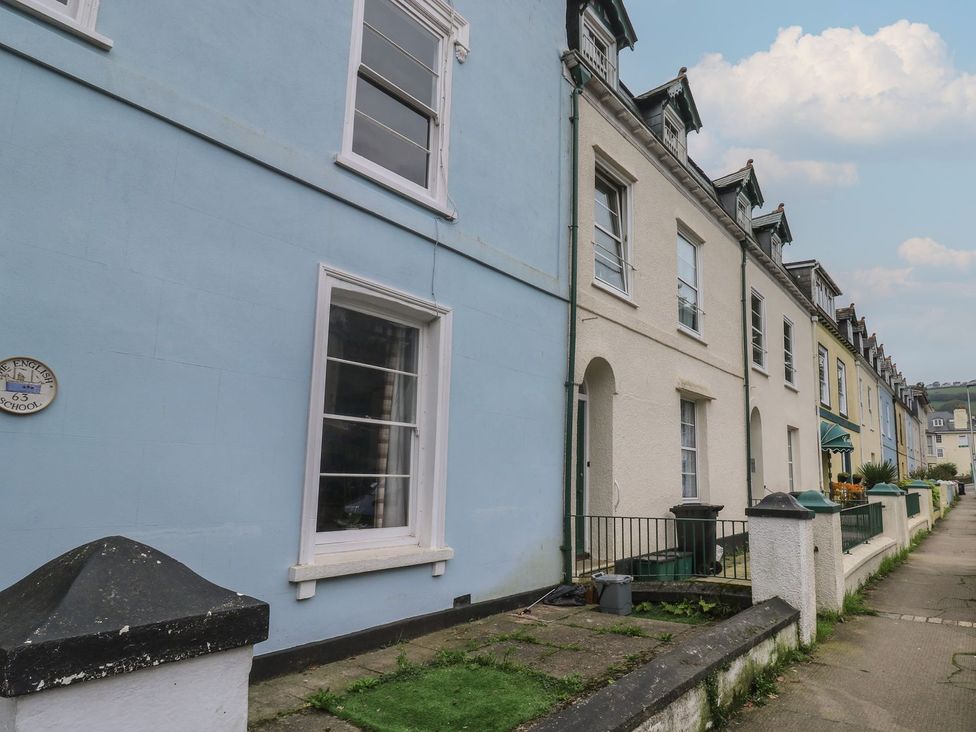 A row of multi-colored buildings on a street at The English School, Flat 2 Dartmouth
