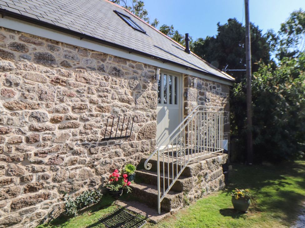 A stone exterior with stairs and a door at The Old Byre in Falmouth