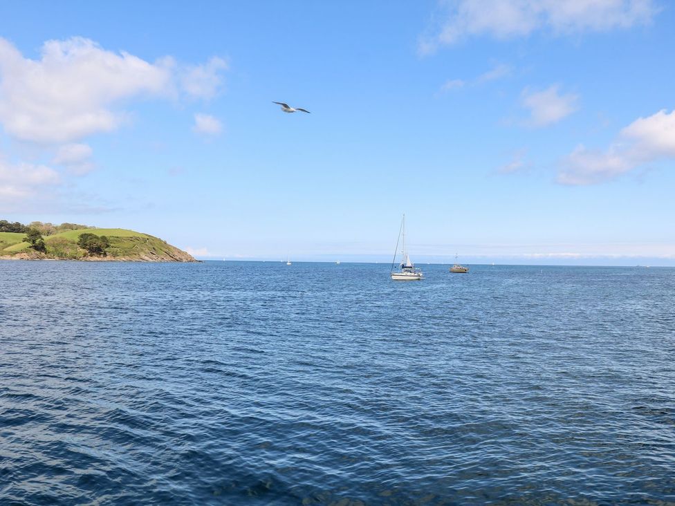 A view of water with sailboats and an island at The Old Byre in Falmouth