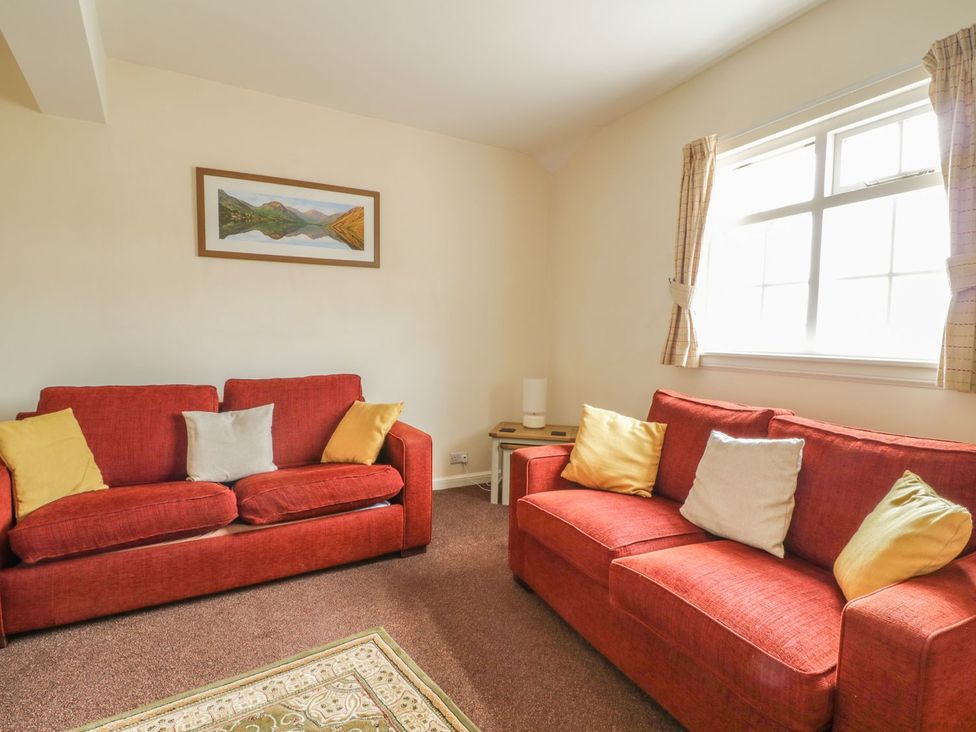 A living room with two sofas and a window at Cottage No 9 in Keswick