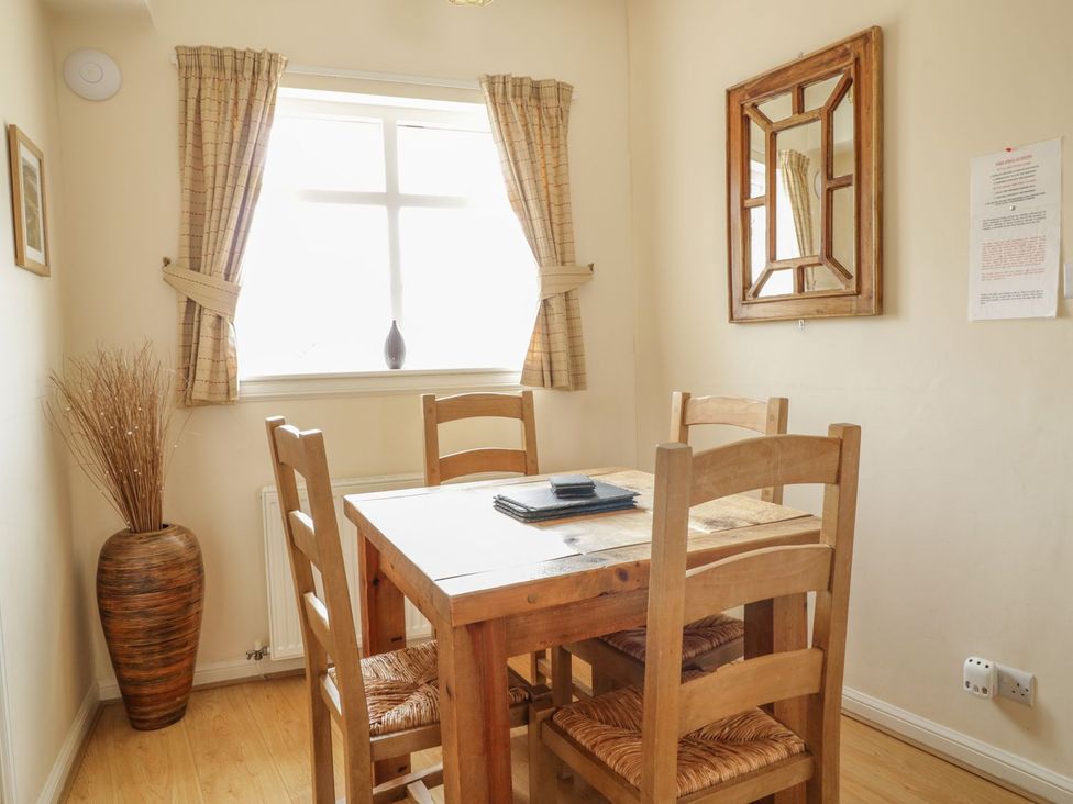 A dining room with a table and chairs at Cottage No 9 in Keswick