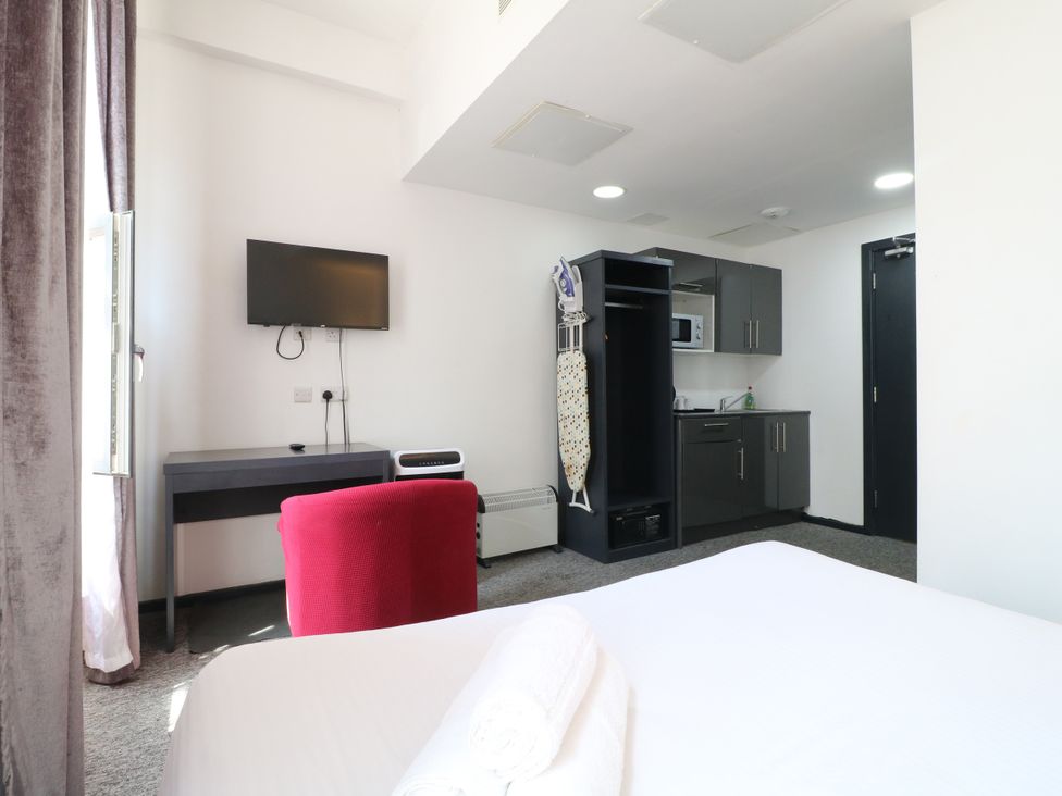 A bedroom with a desk and television at Apartments 212 in Nottingham