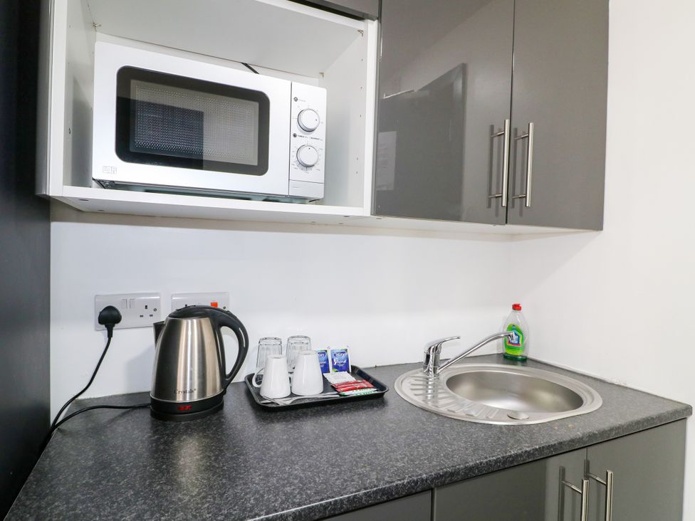 A kitchen with a microwave and kettle at Apartments 212 in Nottingham