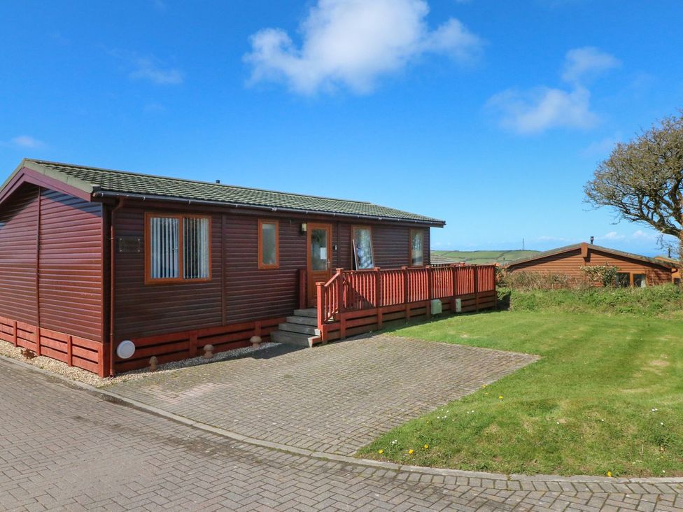 A wooden cabin with a deck and steps at 1 Ocean Terrace Ilfracombe