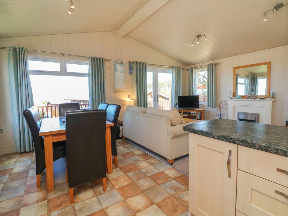 A living room with a dining area and sofa at 1 Ocean Terrace in Ilfracombe