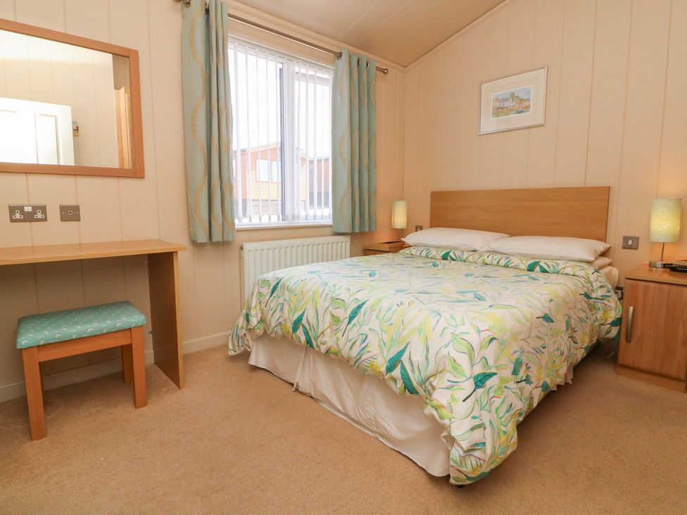 A bedroom with a bed and desk at 1 Ocean Terrace in Ilfracombe