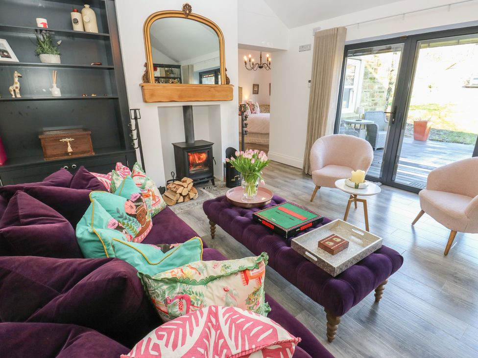 A living room with a fireplace and comfortable seating at The Summerhouse in 