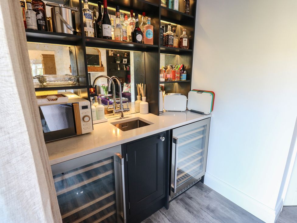 A kitchen with a sink, countertop and barware at The Summerhouse in 
