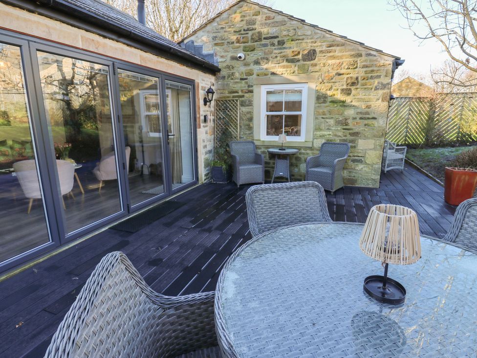 An outdoor seating area with a table and chairs at The Summerhouse in 