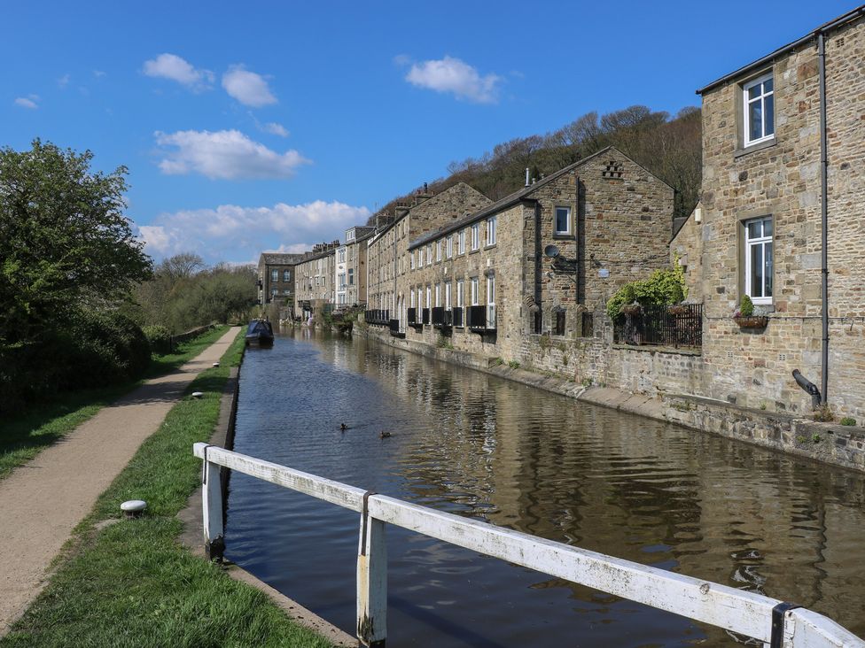 A canal with buildings alongside and a pathway at The Summerhouse in Kildwick
