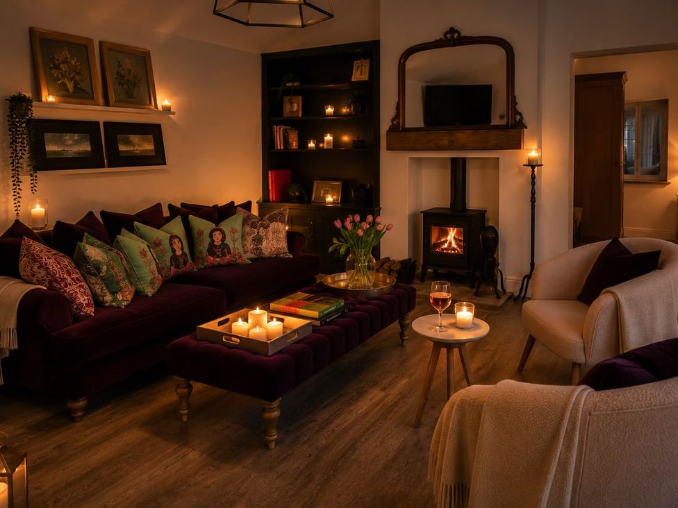 A living room with a couch, table, and fireplace at The Summerhouse in Kildwick
