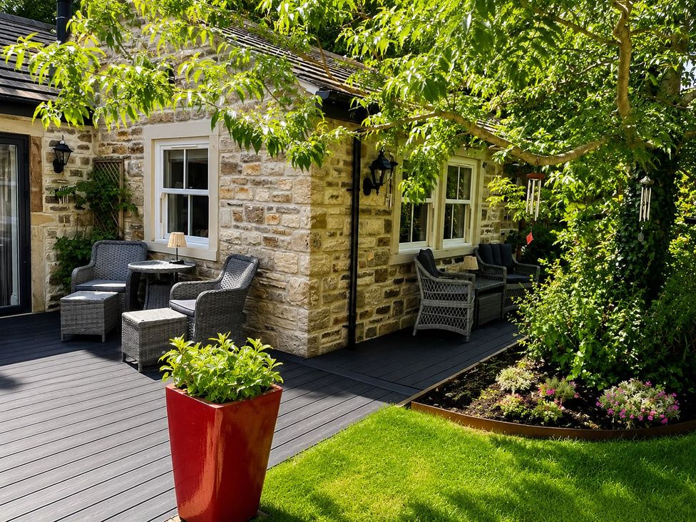 An outdoor seating area with chairs and a table at The Summerhouse Kildwick