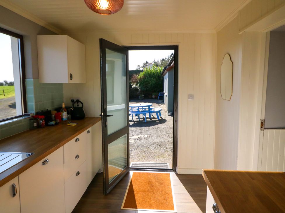 A kitchen with a door leading outside at Thadg and Hannah’s in Miltown