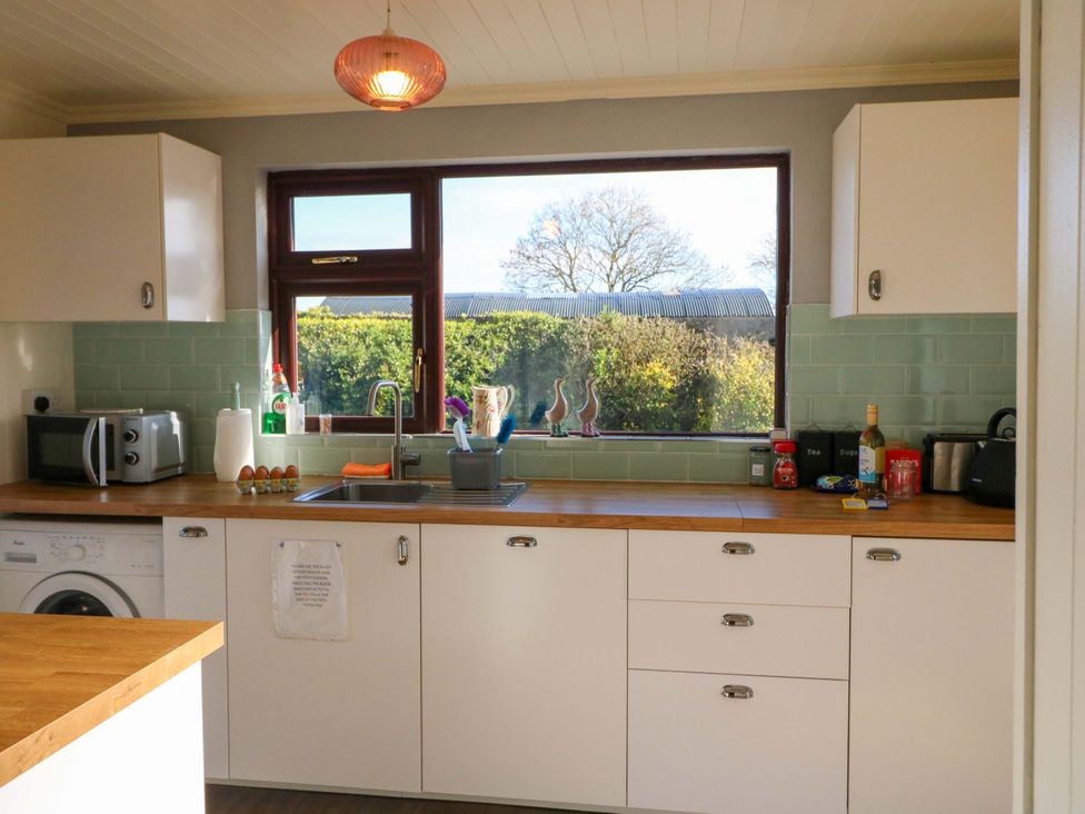 A kitchen with a sink and window view at Thadg and Hannah’s in Miltown