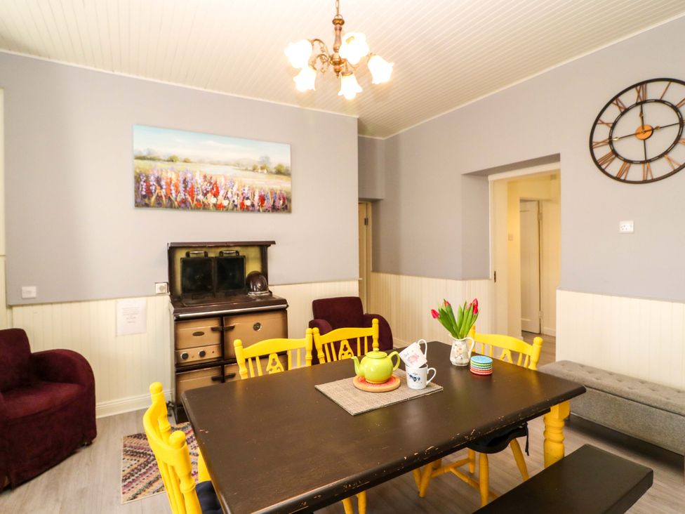 A dining room with yellow chairs and a table at Thadg and Hannah’s in Miltown