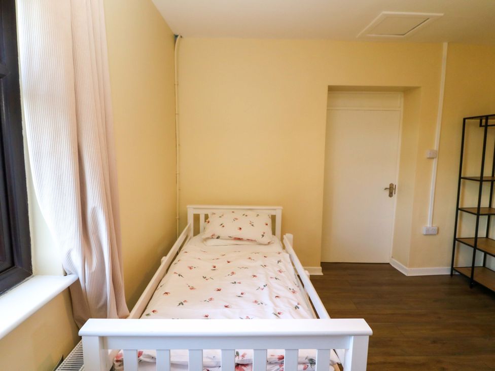 A bedroom with a bed and a shelf at Thadg and Hannah’s in Miltown