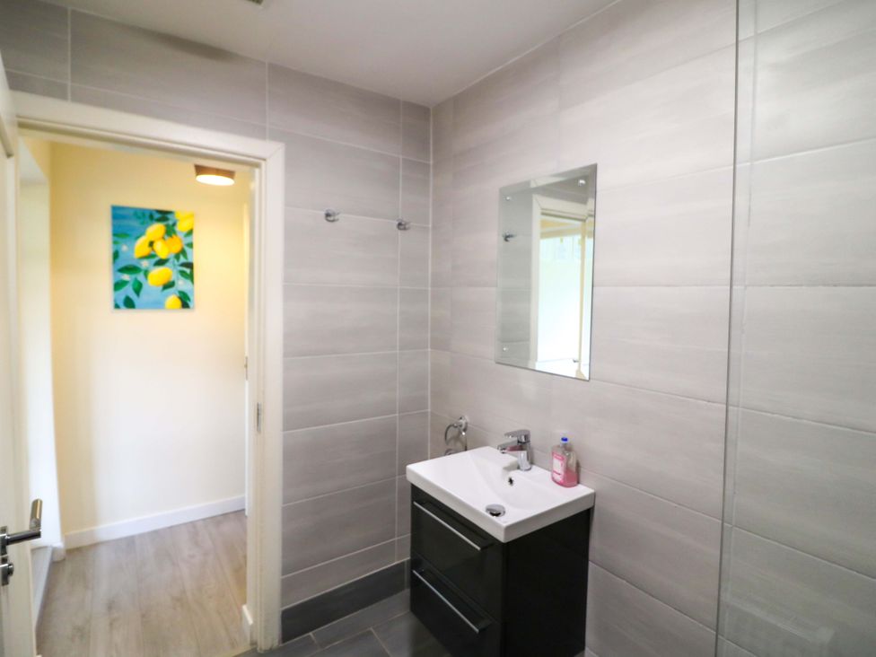 A bathroom with a sink and mirror at Thadg and Hannah’s in Miltown