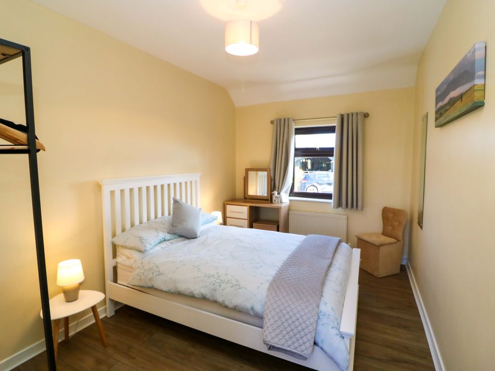 A bedroom with a bed and table at Thadg and Hannah’s in Miltown