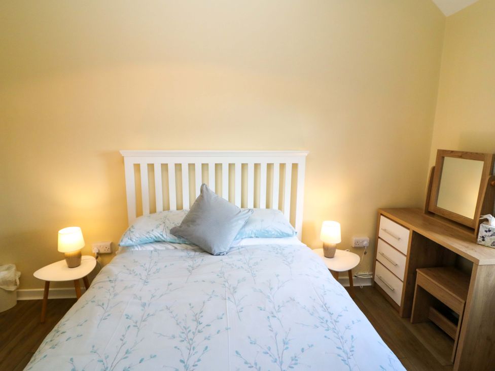 A bedroom with a bed and dresser at Thadg and Hannah’s in Miltown