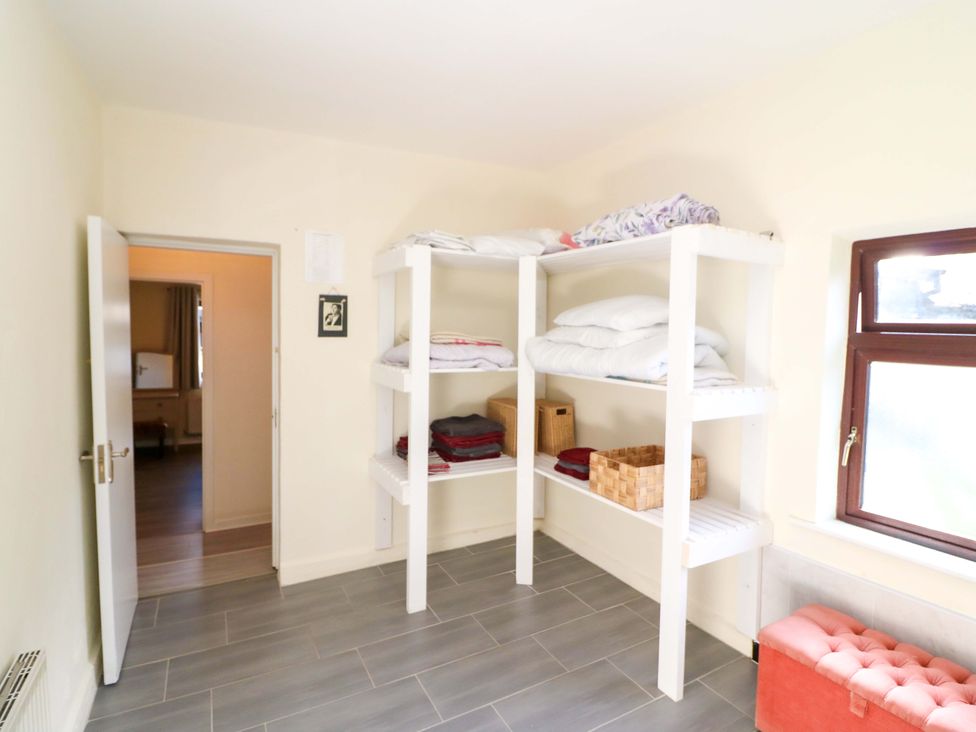 A storage room with shelves and bedding at Thadg and Hannah’s in Miltown