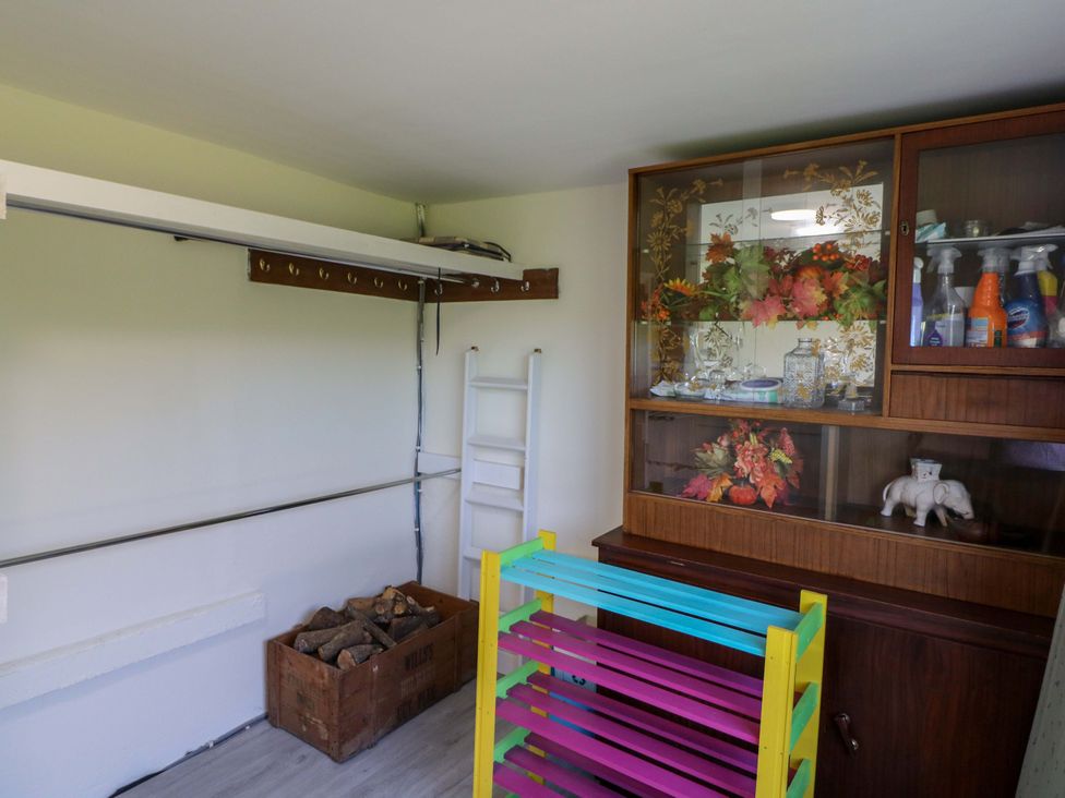 A storage room with a glass cabinet and wooden box at Thadg and Hannah’s in Miltown