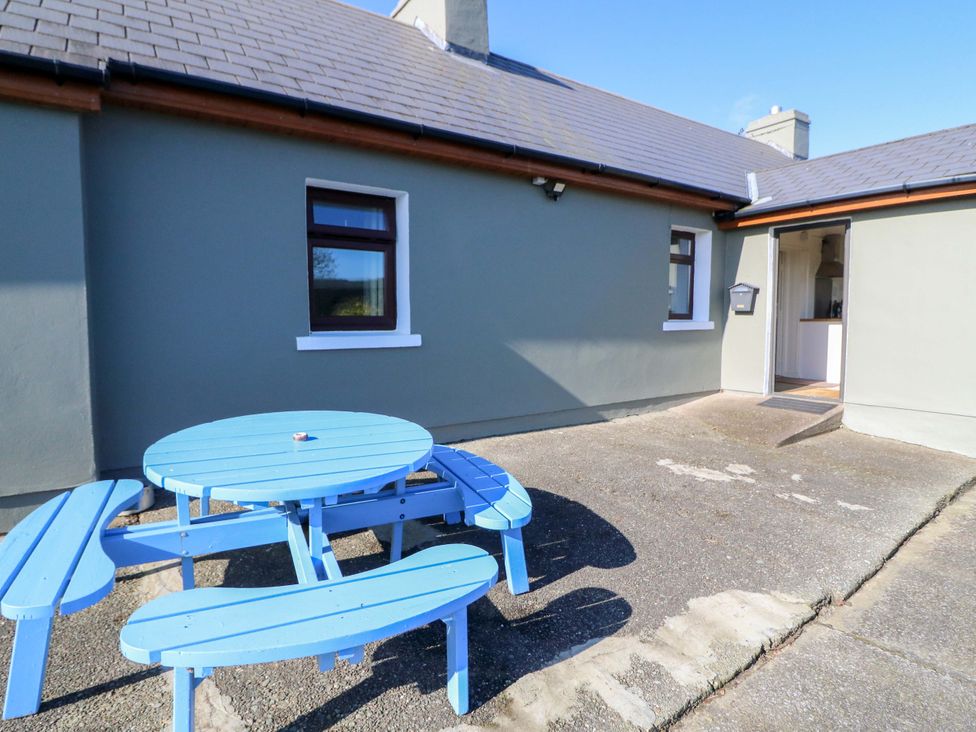 An outdoor area with a blue table and benches at Thadg and Hannah’s in Miltown