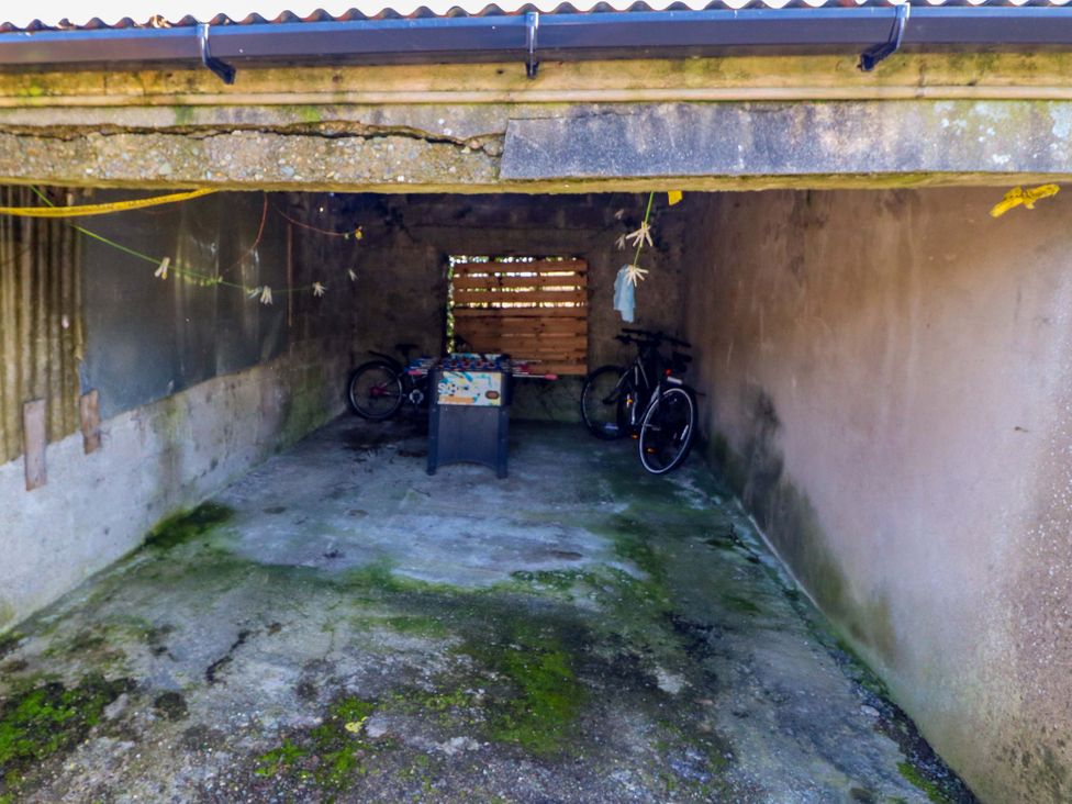 A garage with bicycles and table at Thadg and Hannah’s in Miltown