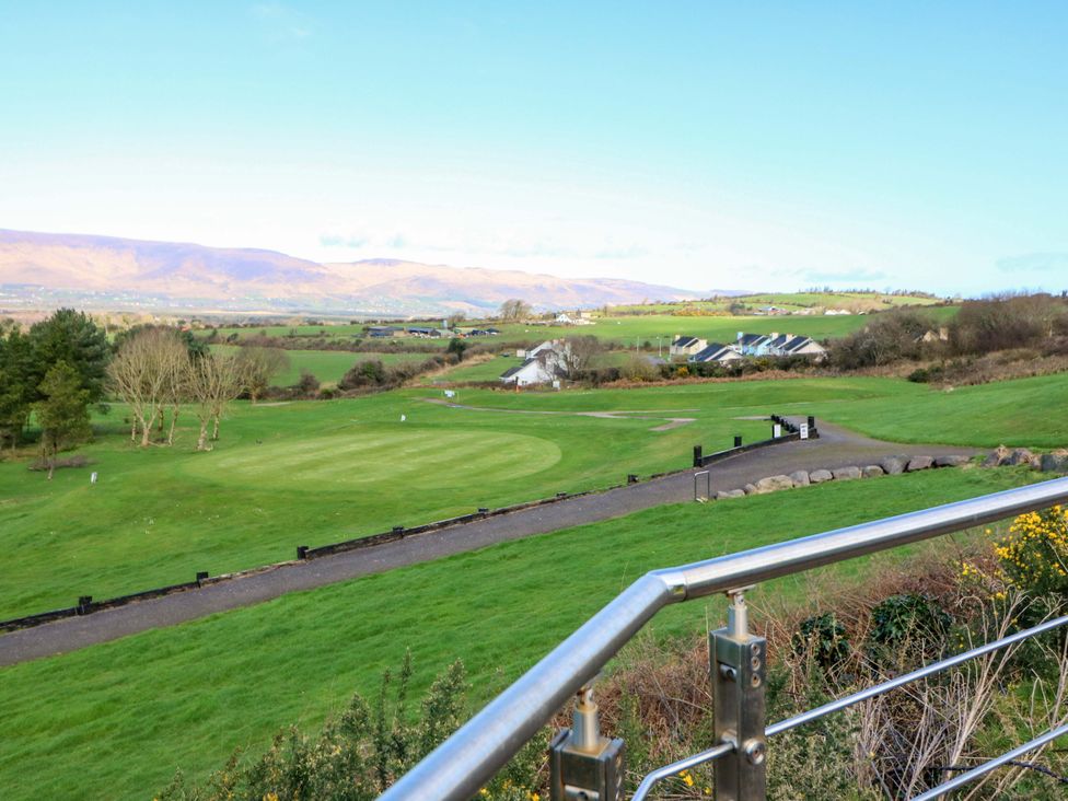 A view of a golf course with green grass and trees at Thadg and Hannah’s in Miltown