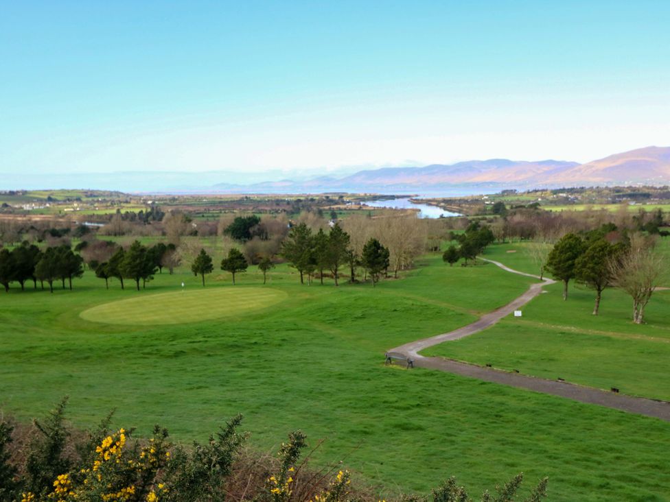A golf course with trees and a river at Thadg and Hannah’s in Miltown