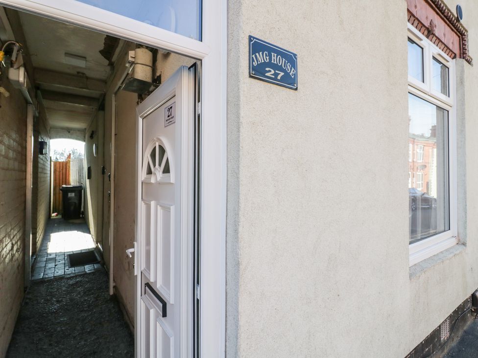 An exterior view of a doorway and pathway at JMG House in West Bromwich